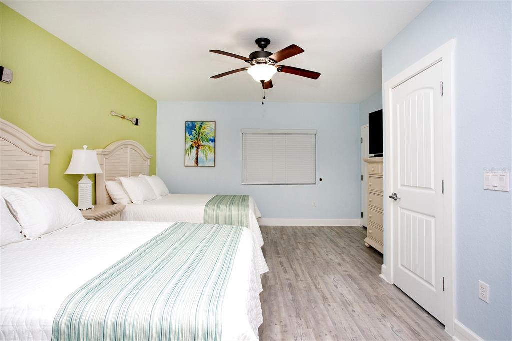 399 2nd Street, Unit 417 Indian Rocks Beach, FL 33785 - Photo 13 of 35 a bed room with a bed and a ceiling fan
