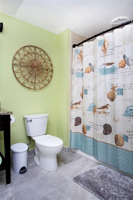 399 2nd Street, Unit 417 Indian Rocks Beach, FL 33785 - Photo 14 of 35 a bathroom with a toilet and a shower