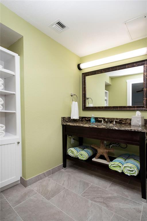 399 2nd Street, Unit 417 Indian Rocks Beach, FL 33785 - Photo 15 of 35 a living room with a table and a fireplace