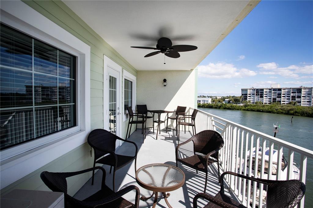 399 2nd Street, Unit 417 Indian Rocks Beach, FL 33785 - Photo 16 of 35 a balcony with table and chairs