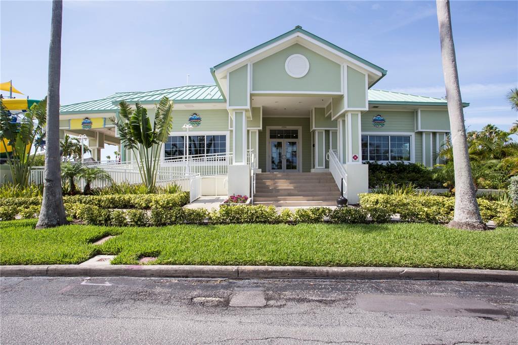 399 2nd Street, Unit 417 Indian Rocks Beach, FL 33785 - Photo 19 of 35 a front view of a house with a yard and potted plants