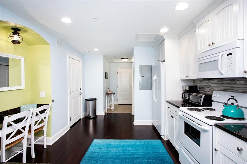 399 2nd Street, Unit 417 Indian Rocks Beach, FL 33785 - Photo 5 of 35 a kitchen with stainless steel appliances a stove a sink and a refrigerator
