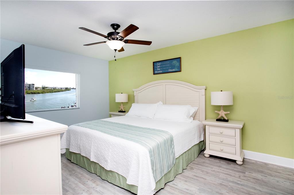 399 2nd Street, Unit 417 Indian Rocks Beach, FL 33785 - Photo 10 of 35 a bedroom with a bed and a flat screen tv