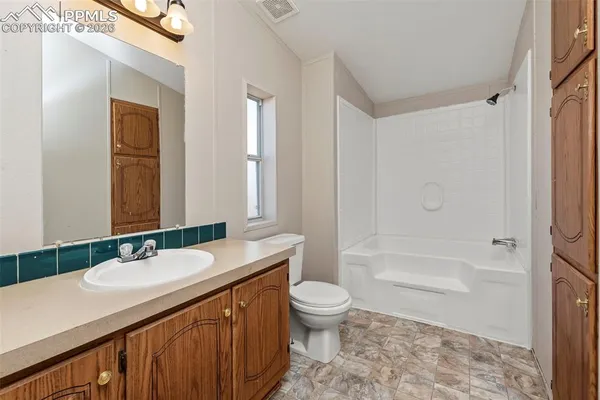 a kitchen with a refrigerator sink and cabinets