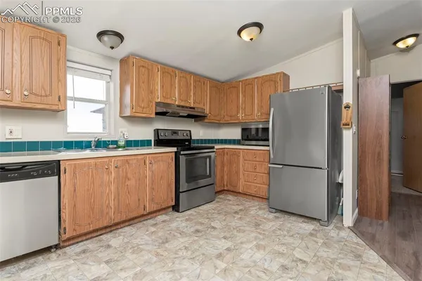 a room with a sink cabinets and utility room
