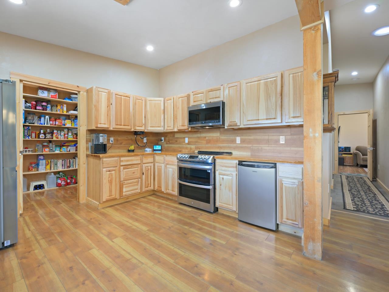 2209 Hatton Place Montrose, CO 81401 - Photo 11 of 42 a kitchen with stainless steel appliances granite countertop a stove top oven a sink and a microwave