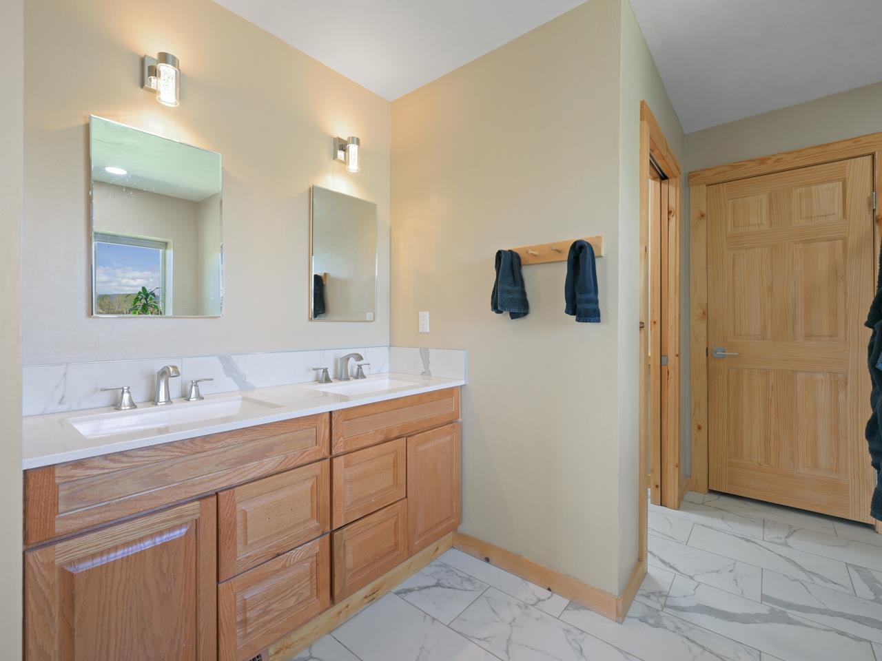 2209 Hatton Place Montrose, CO 81401 - Photo 19 of 42 a bathroom with a double vanity sink and mirror