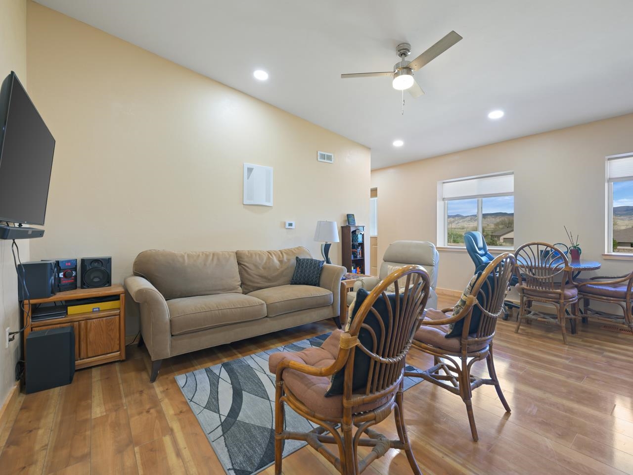2209 Hatton Place Montrose, CO 81401 - Photo 25 of 42 a living room with furniture a flat screen tv and kitchen view