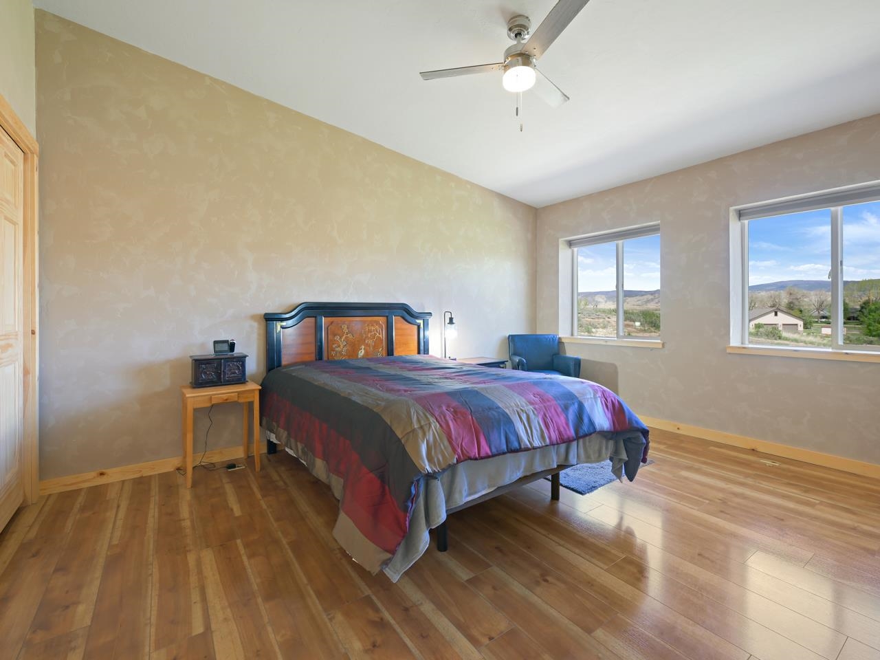 2209 Hatton Place Montrose, CO 81401 - Photo 27 of 42 a spacious bedroom with a bed and wooden floor
