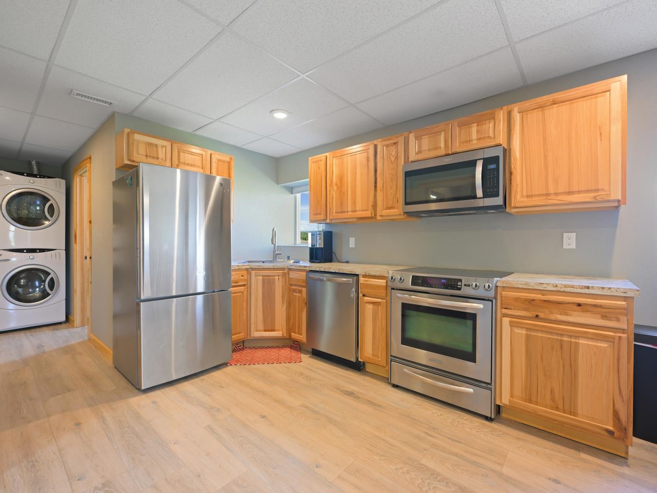 2209 Hatton Place Montrose, CO 81401 - Photo 29 of 42 a kitchen with stainless steel appliances a stove a refrigerator a microwave a sink and cabinets
