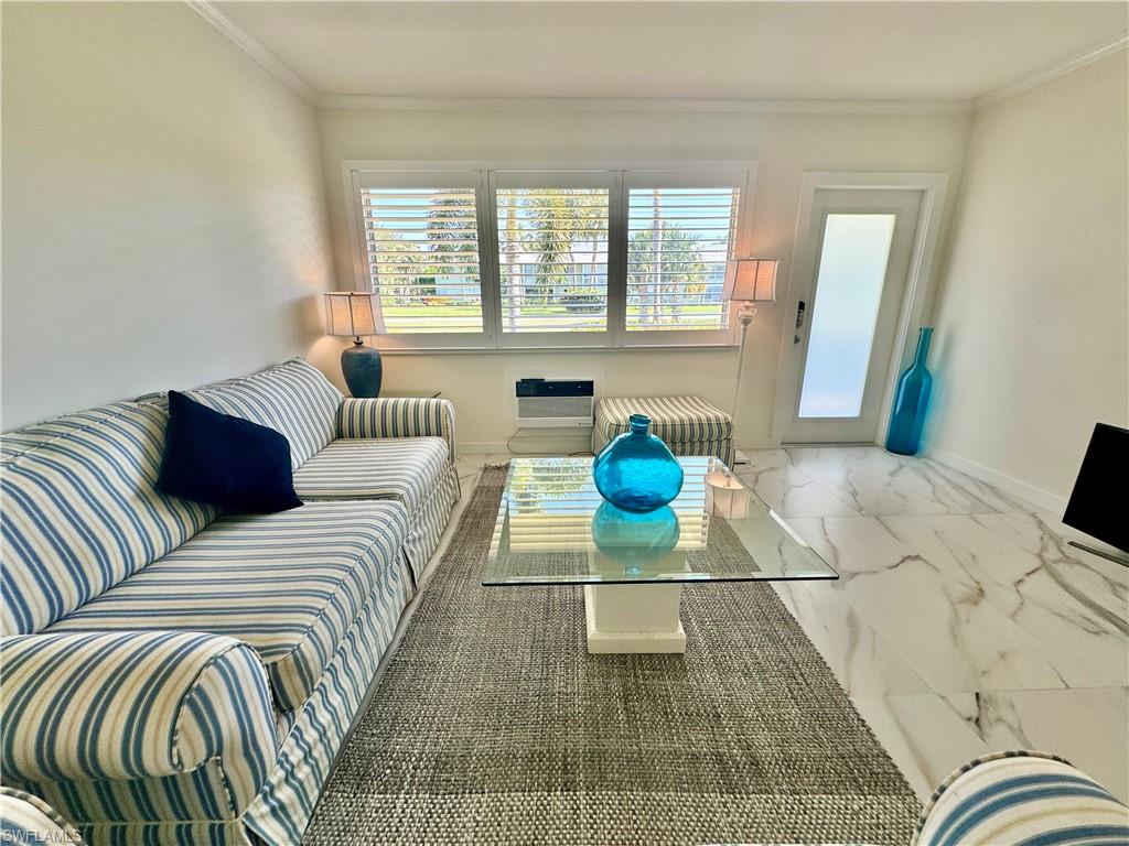 473 12th Avenue South, Unit B7 Naples, FL 34102 - Photo 1 of 21 Tiled living room featuring ornamental molding