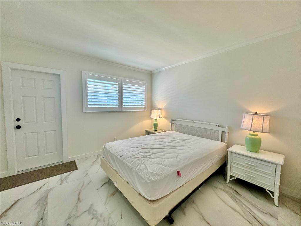 473 12th Avenue South, Unit B7 Naples, FL 34102 - Photo 11 of 21 Bedroom featuring ornamental molding