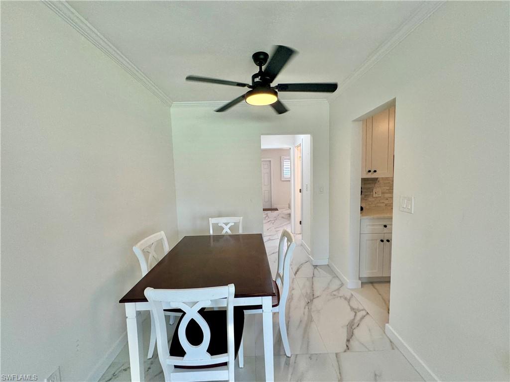 473 12th Avenue South, Unit B7 Naples, FL 34102 - Photo 13 of 21 Dining area featuring ornamental molding, ceiling fan, and light tile floors