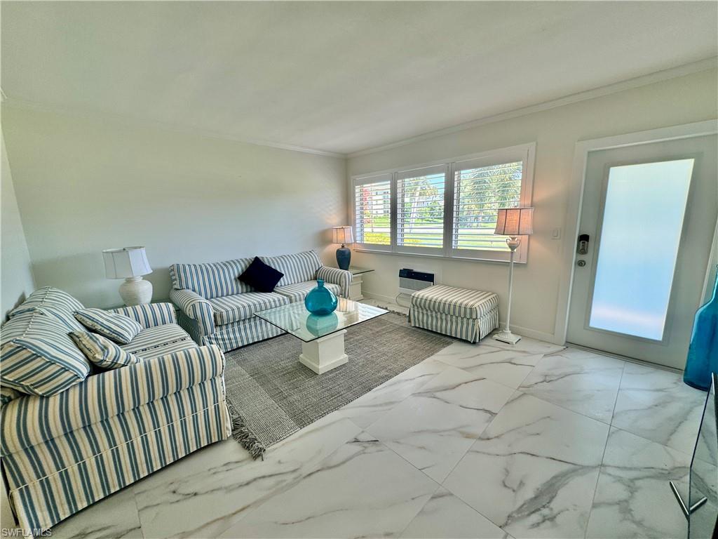 473 12th Avenue South, Unit B7 Naples, FL 34102 - Photo 2 of 21 Tiled living room with crown molding