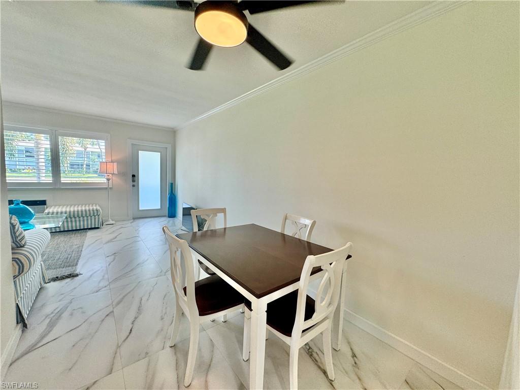 473 12th Avenue South, Unit B7 Naples, FL 34102 - Photo 5 of 21 Dining area with ceiling fan, light tile flooring, and ornamental molding