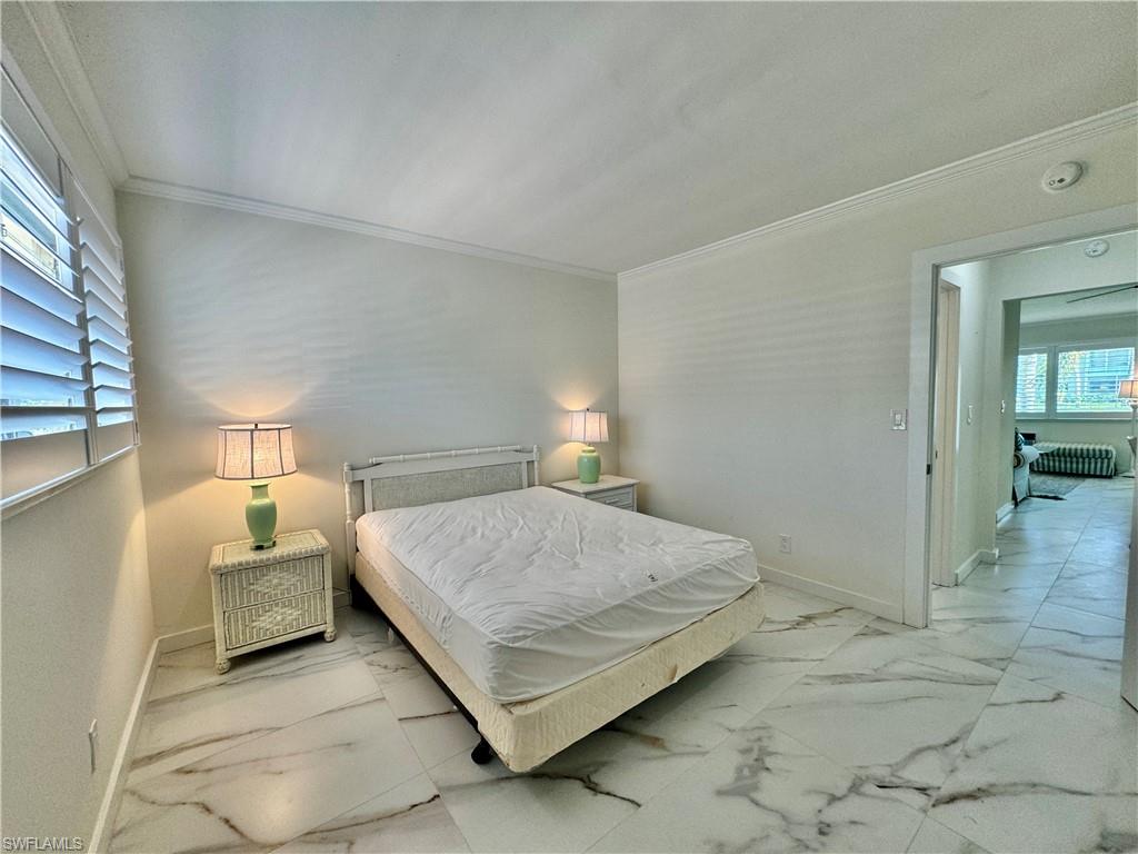 473 12th Avenue South, Unit B7 Naples, FL 34102 - Photo 6 of 21 Bedroom featuring tile floors, multiple windows, and crown molding