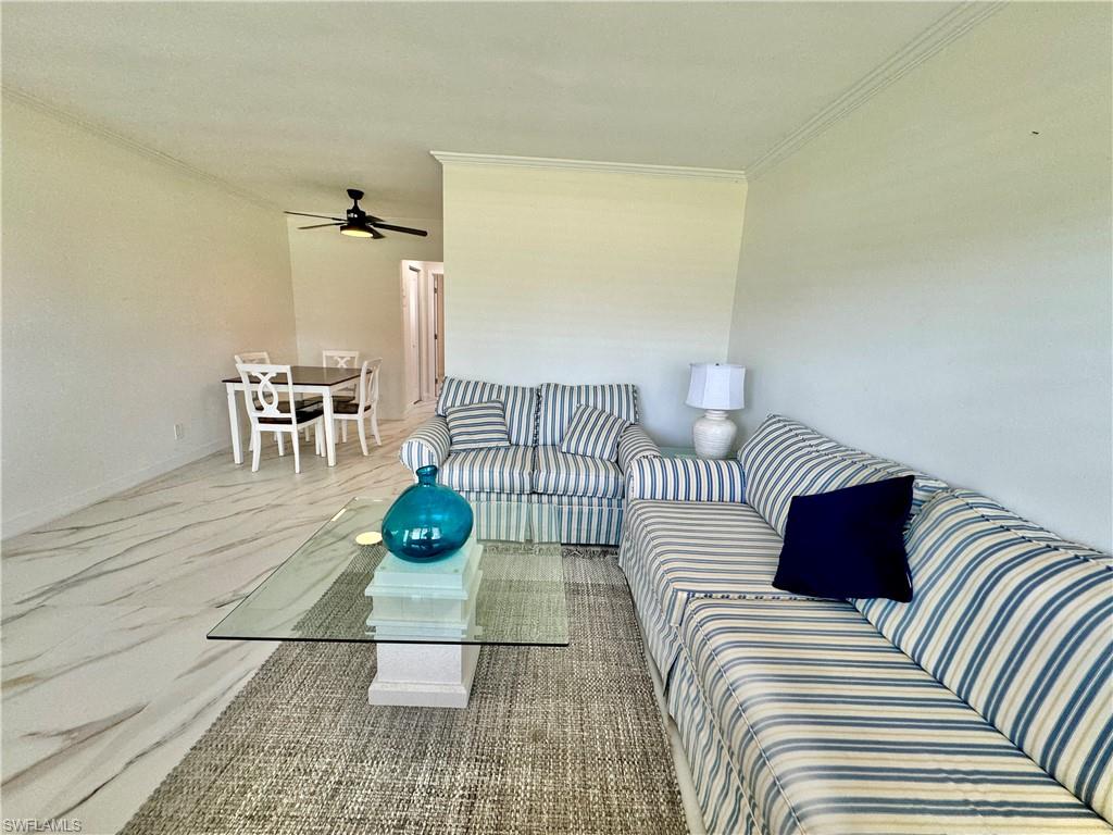 473 12th Avenue South, Unit B7 Naples, FL 34102 - Photo 10 of 21 Living room featuring ornamental molding and ceiling fan