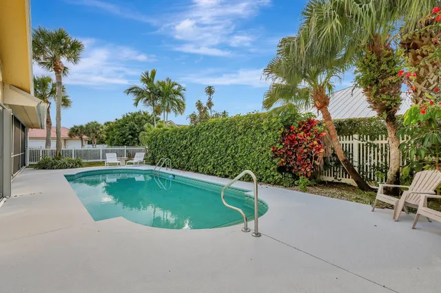 a view of a house with swimming pool and sitting area