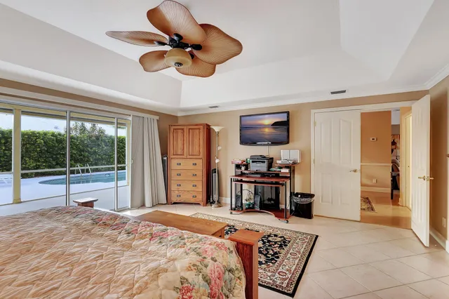 a large white kitchen with kitchen island a sink white cabinets and chairs