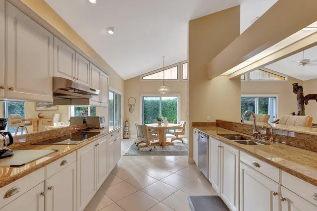 a large kitchen with stainless steel appliances granite countertop a lot of counter space and wooden floors