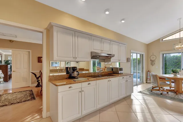 a kitchen with stainless steel appliances granite countertop a refrigerator and a stove top oven