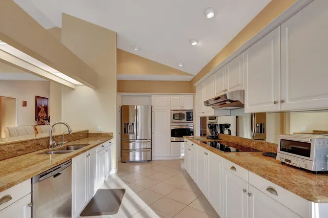 a dining room with furniture a chandelier and glass door
