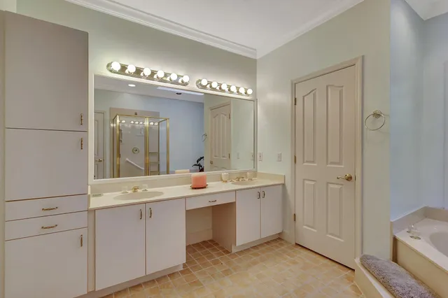 a bathroom with a double vanity sink toilet mirror and shower