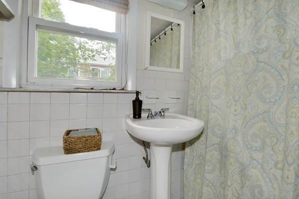 7-9 Sparkill Street Watertown, MA 02472 - Photo 11 of 27 a bathroom with a sink a toilet and mirror