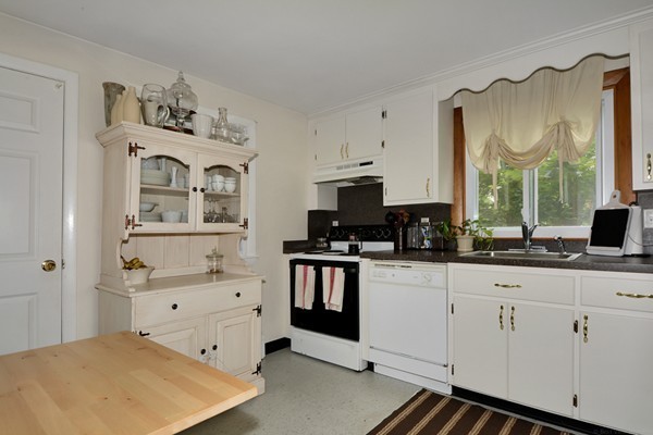 7-9 Sparkill Street Watertown, MA 02472 - Photo 13 of 27 a kitchen with stainless steel appliances a sink and cabinets