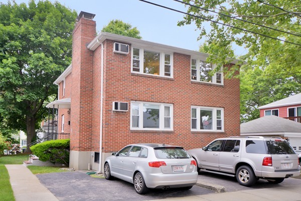 7-9 Sparkill Street Watertown, MA 02472 - Photo 2 of 27 a car parked in front of a house