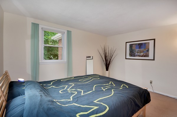 7-9 Sparkill Street Watertown, MA 02472 - Photo 21 of 27 a bed sitting in a bedroom next to a window