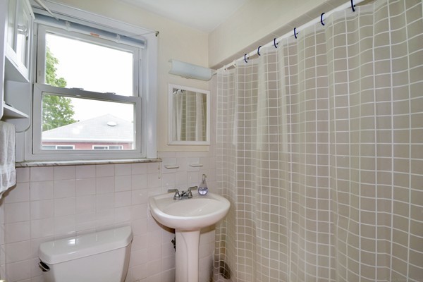 7-9 Sparkill Street Watertown, MA 02472 - Photo 22 of 27 a bathroom with a sink a toilet and window
