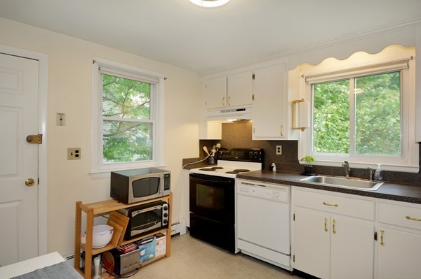 7-9 Sparkill Street Watertown, MA 02472 - Photo 24 of 27 a kitchen with cabinets appliances a sink and a window