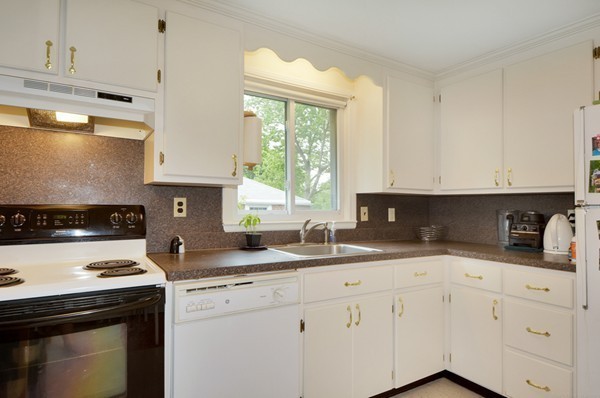 7-9 Sparkill Street Watertown, MA 02472 - Photo 25 of 27 a kitchen with granite countertop white cabinets and white appliances