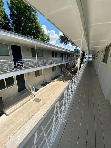 a roof deck with table and chairs