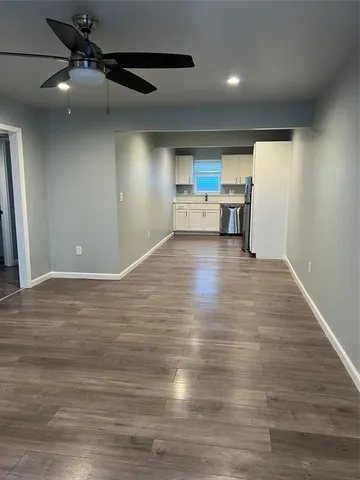 a view of a kitchen with a sink and cabinets