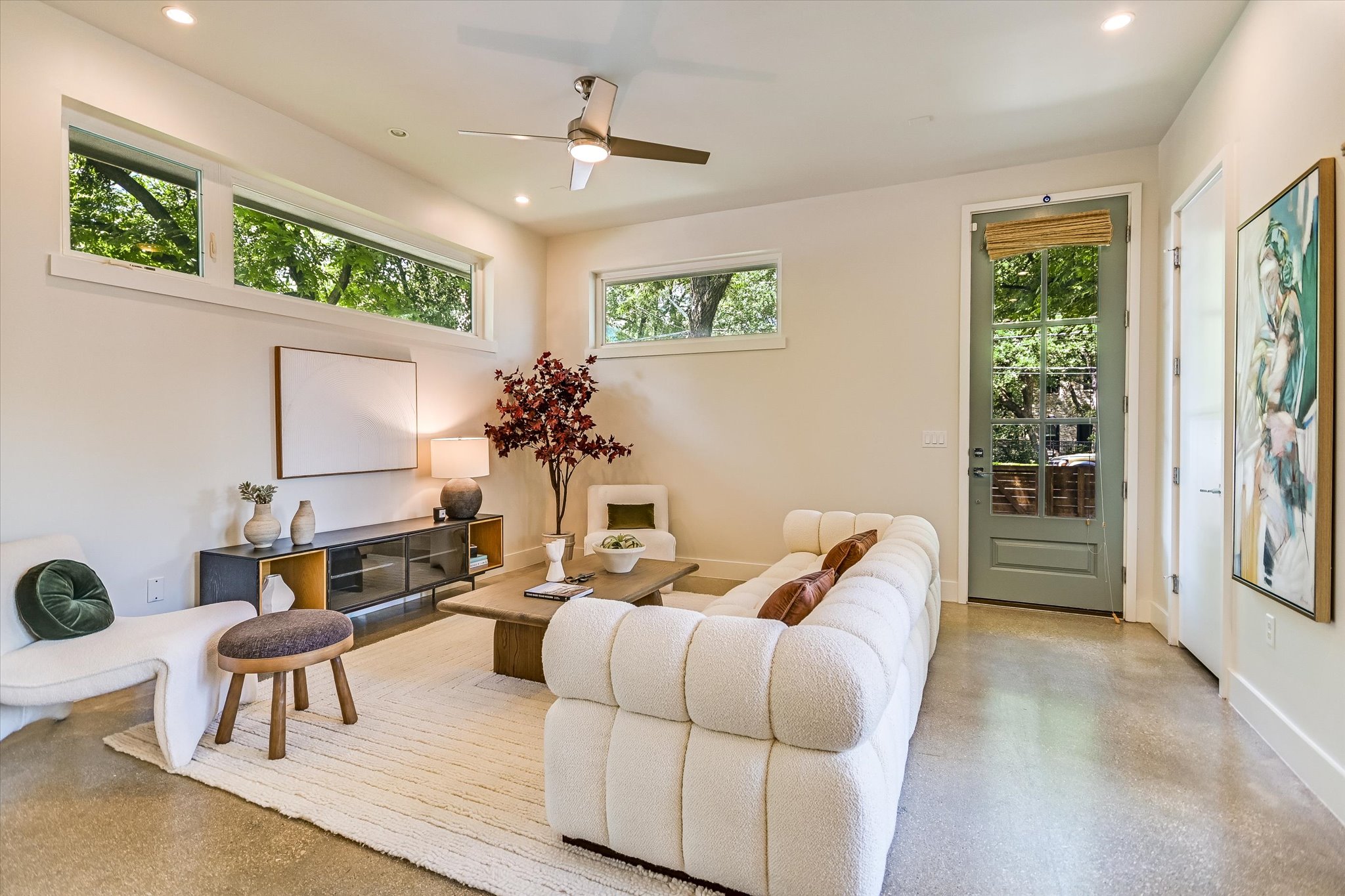 1605 Hether Street Austin, TX 78704 - Photo 7 of 26 Living area featuring polished concrete flooring, a ceiling fan, recessed lighting, transom windows, and a glass-paneled door with an integrated shade