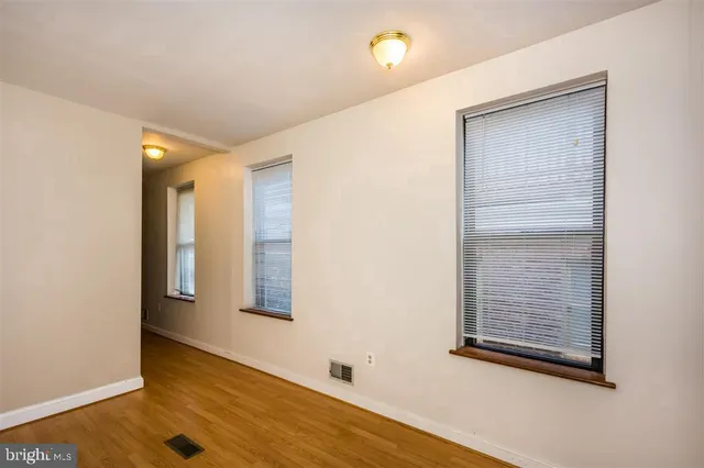 wooden floor in an empty room with a fireplace