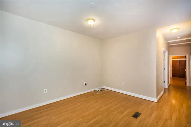 a kitchen with granite countertop a stove a sink and a refrigerator