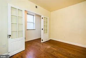 a view of empty room with wooden floor