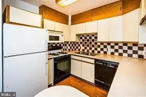 a kitchen with stainless steel appliances a refrigerator and a stove top oven