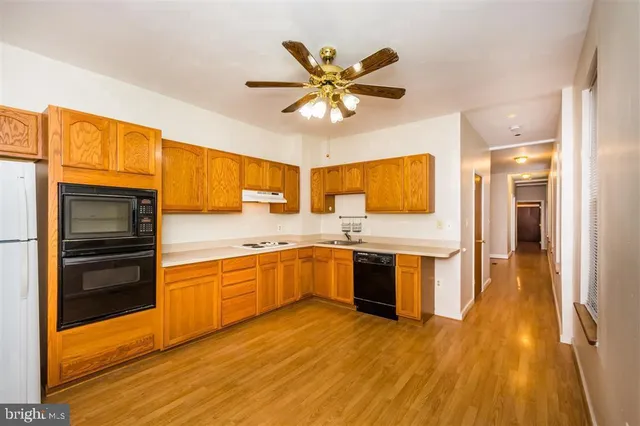 a kitchen with a sink appliances and cabinets