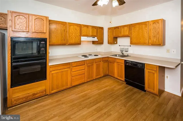a kitchen with stainless steel appliances granite countertop a sink and cabinets