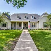 front view of a brick house with a yard