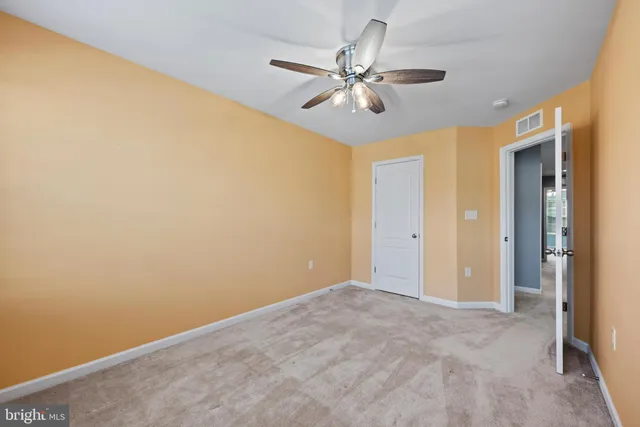 a view of a big room with wooden floor and closet in a room