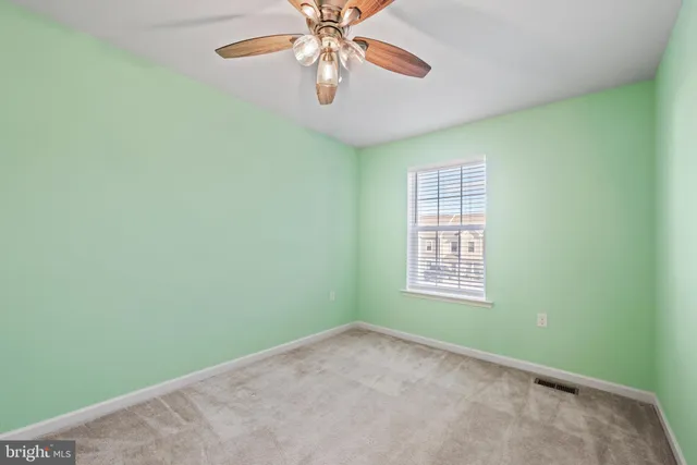 a view of a livingroom with a ceiling fan and window