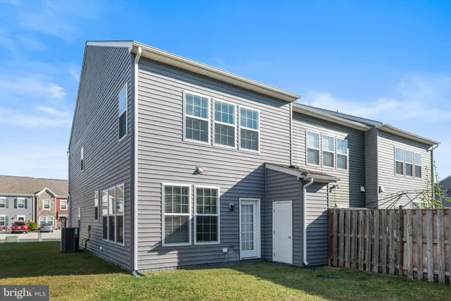 a view of house with a backyard