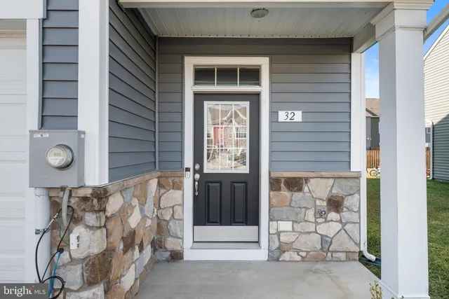 a front view of a house with a door and a window
