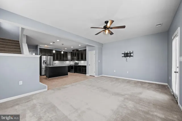 a view of a kitchen with a sink and cabinets