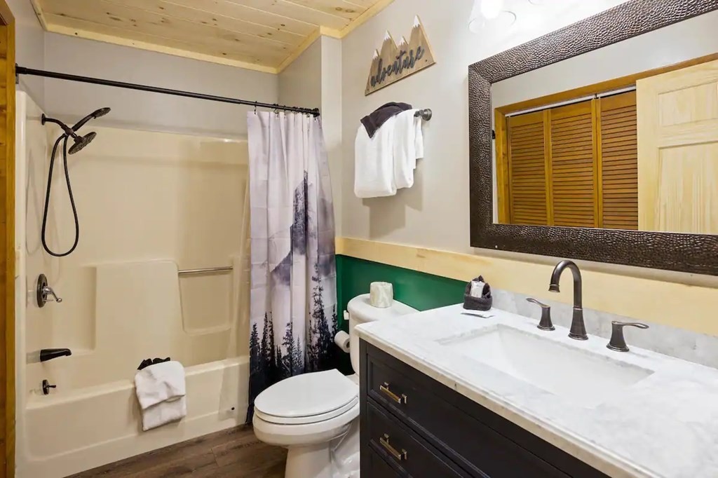 3409 Line Springs Road Sevierville, TN 37862 - Photo 22 of 35 a bathroom with a granite countertop sink toilet and shower